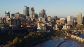 5.7K aerial stock footage focus on city skyline while flying by the river at sunrise, Downtown Minneapolis, Minnesota Aerial Stock Footage | DX0001_002312