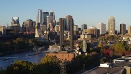 5.7K aerial stock footage power plant and smoke stacks with skyline in background at sunrise, Downtown Minneapolis, Minnesota Aerial Stock Footage | DX0001_002313