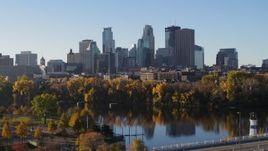5.7K aerial stock footage of the skyline seen from a park by the river, Downtown Minneapolis, Minnesota Aerial Stock Footage | DX0001_002328