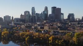5.7K aerial stock footage of the skyline seen during descent by the river, Downtown Minneapolis, Minnesota Aerial Stock Footage | DX0001_002331