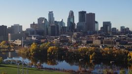 5.7K aerial stock footage descend by the river with view of city skyline, Downtown Minneapolis, Minnesota Aerial Stock Footage | DX0001_002334