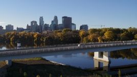 5.7K aerial stock footage fly over bridge and river for view of city skyline, Downtown Minneapolis, Minnesota Aerial Stock Footage | DX0001_002335