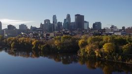 5.7K aerial stock footage reverse view of skyline of Downtown Minneapolis, Minnesota, seen from river, reveal bridge Aerial Stock Footage | DX0001_002341