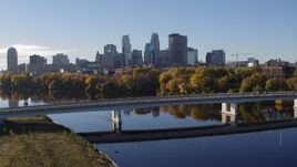 5.7K aerial stock footage fly over bridge spanning Mississippi River with view of skyline, Downtown Minneapolis, Minnesota Aerial Stock Footage | DX0001_002343
