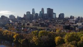 5.7K aerial stock footage reverse view of the city skyline, revealing the river and a bridge, Downtown Minneapolis, Minnesota Aerial Stock Footage | DX0001_002345