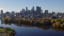 5.7K aerial stock footage of flying by the river with a view of the skyline of Downtown Minneapolis, Minnesota Aerial Stock Footage | DX0001_002349