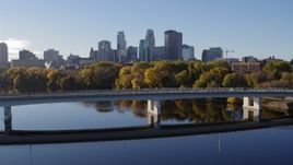 5.7K aerial stock footage flyby a bridge spanning river with a view of the skyline of Downtown Minneapolis, Minnesota Aerial Stock Footage | DX0001_002352