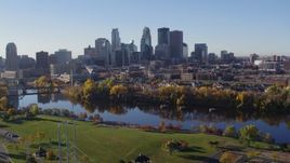5.7K aerial stock footage descend toward riverfront park with a view of the skyline of Downtown Minneapolis, Minnesota Aerial Stock Footage | DX0001_002353