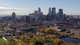 5.7K aerial stock footage flying by bridges spanning the river and the city skyline, Downtown Minneapolis, Minnesota Aerial Stock Footage | DX0001_002355
