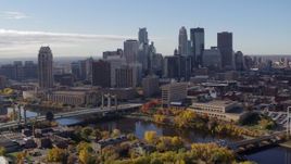 5.7K aerial stock footage of flying by bridges spanning the river and the city's skyline, Downtown Minneapolis, Minnesota Aerial Stock Footage | DX0001_002356