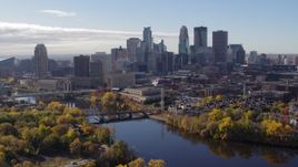 5.7K aerial stock footage of passing by the Mississippi River and the city's skyline, Downtown Minneapolis, Minnesota Aerial Stock Footage | DX0001_002357
