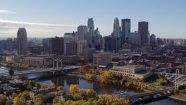 5.7K aerial stock footage flying by the city's skyline and bridges spanning the river, Downtown Minneapolis, Minnesota Aerial Stock Footage | DX0001_002366