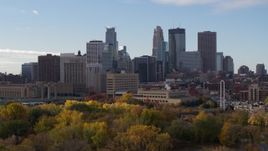 5.7K aerial stock footage ascend from trees to reveal Mississippi River, focus on skyline of Downtown Minneapolis, Minnesota Aerial Stock Footage | DX0001_002368