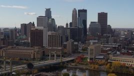 5.7K aerial stock footage fly near bridge and towering skyscrapers of the city skyline, Downtown Minneapolis, Minnesota Aerial Stock Footage | DX0001_002381