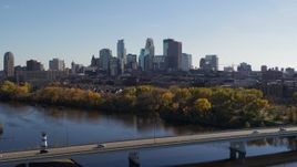 5.7K aerial stock footage reverse view of the city skyline, reveal bridge spanning Mississippi River, Downtown Minneapolis, Minnesota Aerial Stock Footage | DX0001_002455