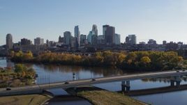 5.7K aerial stock footage wide view of the city skyline, seen from bridge spanning Mississippi River, Downtown Minneapolis, Minnesota Aerial Stock Footage | DX0001_002456