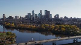 5.7K aerial stock footage wide view of the city skyline, seen from bridge spanning the river, Downtown Minneapolis, Minnesota Aerial Stock Footage | DX0001_002457