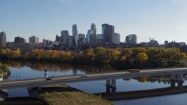 5.7K aerial stock footage flyby bridge over the river with a view of the skyline of Downtown Minneapolis, Minnesota Aerial Stock Footage | DX0001_002463