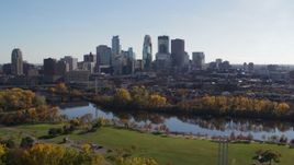 5.7K aerial stock footage of the city skyline seen while descending by riverside park, Downtown Minneapolis, Minnesota Aerial Stock Footage | DX0001_002465
