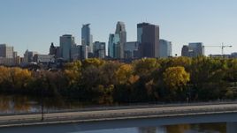5.7K aerial stock footage fly over bridge spanning river and focus on skyline of Downtown Minneapolis, Minnesota Aerial Stock Footage | DX0001_002466