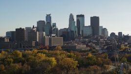 5.7K aerial stock footage focus on the city skyline while flying by trees, Downtown Minneapolis, Minnesota Aerial Stock Footage | DX0001_002481