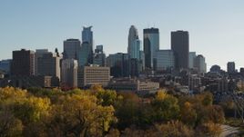 5.7K aerial stock footage ascend over trees to focus on the city skyline, Downtown Minneapolis, Minnesota Aerial Stock Footage | DX0001_002483