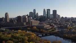 5.7K aerial stock footage ascend over trees and approach the city skyline, Downtown Minneapolis, Minnesota Aerial Stock Footage | DX0001_002486