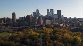 5.7K aerial stock footage of flying by fall trees and the city skyline, Downtown Minneapolis, Minnesota Aerial Stock Footage | DX0001_002489