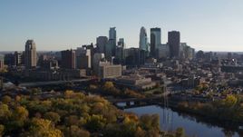 5.7K aerial stock footage of flying by fall trees and the city skyline, ascend over the river, Downtown Minneapolis, Minnesota Aerial Stock Footage | DX0001_002490