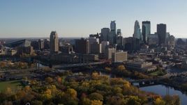 5.7K aerial stock footage of flying by bridge spanning the river and the city skyline, Downtown Minneapolis, Minnesota Aerial Stock Footage | DX0001_002491