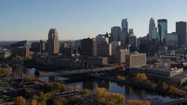 5.7K aerial stock footage of approaching bridge spanning the river and the city skyline, Downtown Minneapolis, Minnesota Aerial Stock Footage | DX0001_002492