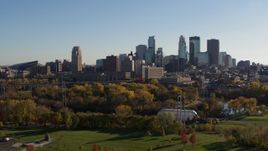 5.7K aerial stock footage flying by park with view of city skyline across the Mississippi River, Downtown Minneapolis, Minnesota Aerial Stock Footage | DX0001_002498