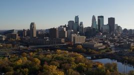 5.7K aerial stock footage descend by trees with view of city skyline and Mississippi River, Downtown Minneapolis, Minnesota Aerial Stock Footage | DX0001_002501