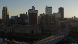 5.7K aerial stock footage fly away from Hennepin Avenue Bridge and apartment buildings at sunset in Downtown Minneapolis, Minnesota Aerial Stock Footage | DX0001_002503