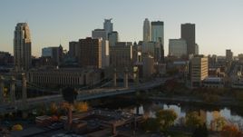 5.7K aerial stock footage flying by Hennepin Avenue Bridge and city skyline at sunset, Downtown Minneapolis, Minnesota Aerial Stock Footage | DX0001_002515