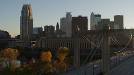 5.7K aerial stock footage descend by USPS and apartment buildings at sunset, reveal bridge in Downtown Minneapolis, Minnesota Aerial Stock Footage | DX0001_002518