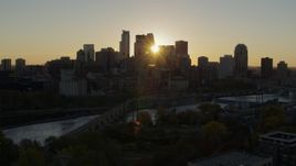 5.7K aerial stock footage of the city skyline across the river while ascending at sunset, Downtown Minneapolis, Minnesota Aerial Stock Footage | DX0001_002521