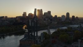 5.7K aerial stock footage of flying by power plant, with the city skyline across river at sunset, Downtown Minneapolis, Minnesota Aerial Stock Footage | DX0001_002523
