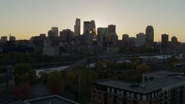 5.7K aerial stock footage of flying by the city skyline across river at sunset, reveal power plant, Downtown Minneapolis, Minnesota Aerial Stock Footage | DX0001_002524