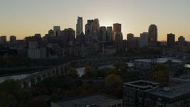 5.7K aerial stock footage view of city skyline during descent by bridge and river at sunset, Downtown Minneapolis, Minnesota Aerial Stock Footage | DX0001_002528