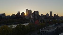 5.7K aerial stock footage of city skyline while flying over power plant and river at sunset, Downtown Minneapolis, Minnesota Aerial Stock Footage | DX0001_002530