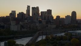 5.7K aerial stock footage of city skyline across the Mississippi River at sunset, and reveal the power plant, Downtown Minneapolis, Minnesota Aerial Stock Footage | DX0001_002536