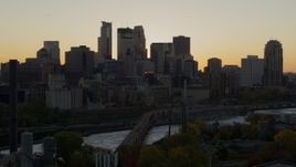 5.7K aerial stock footage ascend to reveal river with view of city skyline in background at sunset, Downtown Minneapolis, Minnesota Aerial Stock Footage | DX0001_002538