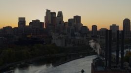5.7K aerial stock footage flyby river with view of city skyline at sunset, reveal the power plant, Downtown Minneapolis, Minnesota Aerial Stock Footage | DX0001_002541