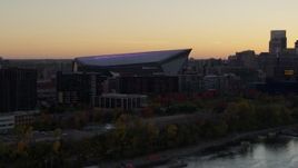 5.7K aerial stock footage approach US Bank Stadium from the river at sunset, Downtown Minneapolis, Minnesota Aerial Stock Footage | DX0001_002543
