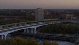5.7K aerial stock footage fly away from a condo complex beside a bridge at sunset, Minneapolis, Minnesota Aerial Stock Footage | DX0001_002550