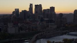 5.7K aerial stock footage of the city's skyline seen from the over side of the river at sunset, Downtown Minneapolis, Minnesota Aerial Stock Footage | DX0001_002554