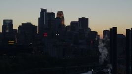 5.7K aerial stock footage flyby smoke stacks with view of the city skyline at twilight, Downtown Minneapolis, Minnesota Aerial Stock Footage | DX0001_002559