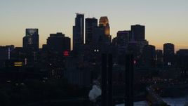 5.7K aerial stock footage of the city skyline across the river at twilight, seen from power plant, Downtown Minneapolis, Minnesota Aerial Stock Footage | DX0001_002566