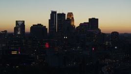 5.7K aerial stock footage ascend by the skyscrapers in the city skyline at twilight, Downtown Minneapolis, Minnesota Aerial Stock Footage | DX0001_002572